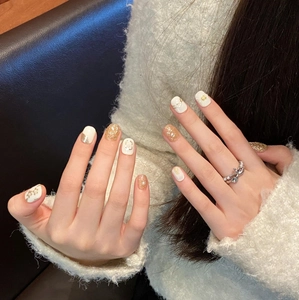 Elegant handmade press-on nails with 3D pearls and gold floral relief details