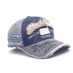 Detailed macro view of retro washed denim cap with distressed fraying and vintage embroidery