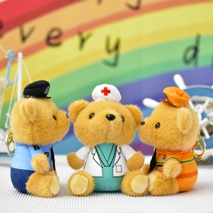 Detail view of plush bear keychains in police, nurse, and worker uniforms