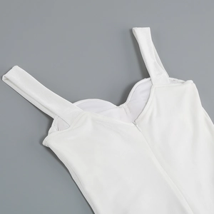 Detail view of the back zipper and shoulder straps on a white velvet party dress
