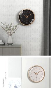 Detail of 12 inch minimalist wall clock with Arabic numerals in gold and black finishes