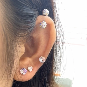 Sparkling crystal stud earrings with 6mm square and heart designs on model ear