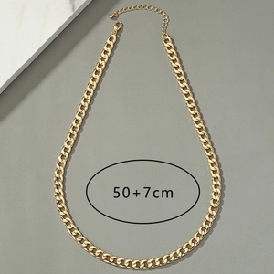 Flat lay view of a gold curb chain necklace with lobster clasp and adjustable 50+7cm length