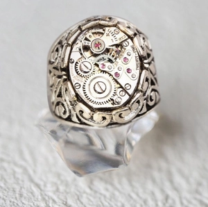 Detailed macro view of steampunk mechanical watch movement ring with twenty-five jewels