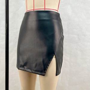 Detail view of high-waisted black PU leather mini skirt with side slit and asymmetric cut