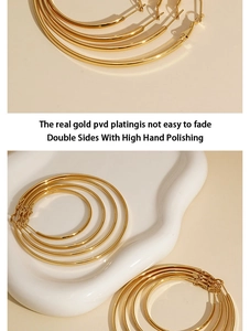 Close-up of high hand-polished PVD gold plated stainless steel hoop earrings on tray