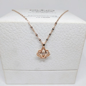 Detailed view of rose gold crown pendant featuring a shimmering central dancing stone