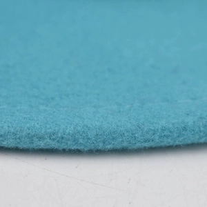Macro shot of light blue felt fedora material showing thick wool fiber texture