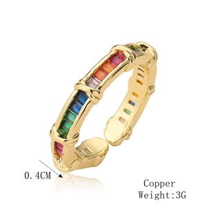 Macro detail of gold-plated copper ring with rainbow zircon stones and 0.4cm width