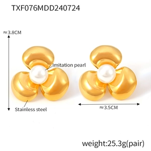 Detailed view showing 3.8cm gold flower earrings with white pearl and steel petals