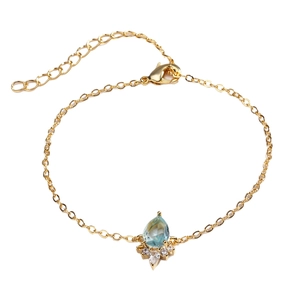Gold unicorn rainbow bracelet for women featuring a pear-cut blue gemstone and zircons