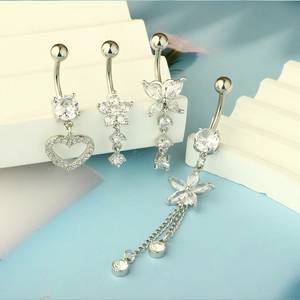 Detailed view of silver belly rings with zircon heart, flower and butterfly designs
