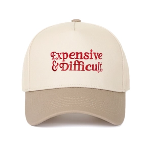 Detailed close-up of embroidered Expensive & Difficult lettering on a two-tone cotton cap