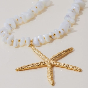 Elegant gold starfish pendant necklace with irregular white beads for beach style