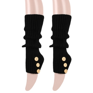 Detail of black ribbed knit leg warmers featuring three vintage wooden buttons