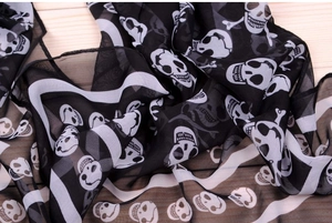 Close-up of black and white skull pattern on lightweight semi-transparent chiffon scarf