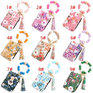 Collection of nine floral pattern card holders with silicone bead wristlet and tassel