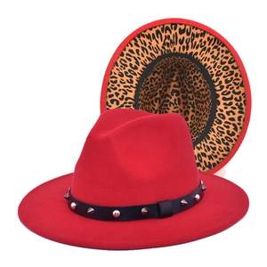 Detail of red wool fedora with leopard print brim and studded leather band decor