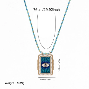 Bohemian long necklace with blue enamel tarot pendant and braided gold cord detail