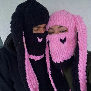 Detail of rabbit ear balaclava with warm thick knit, chains, and metal ring accents