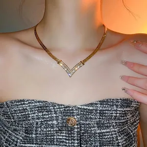 Elegant gold-plated V-shaped rhinestone necklace with flat wide chain on model