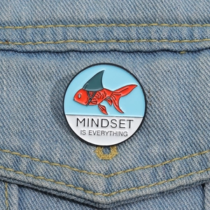 Creative koi fish enamel pin with Mindset is Everything slogan on blue denim jacket