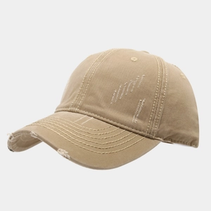 Detail of khaki washed cotton baseball cap featuring distressed edges and ripped textures