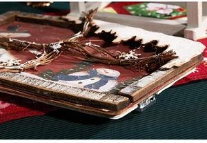 Detail of Santa wall hanging featuring wooden frame LED lights and festive snow texture
