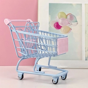 Detailed view of a mini blue and pink metal shopping cart for desktop storage decoration