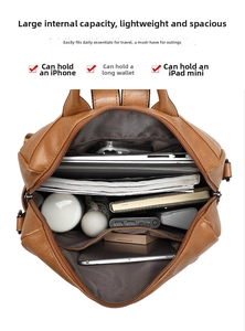 Top view of brown leather backpack interior showing capacity for laptop, iPad and umbrella