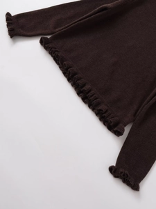 Detail view of dark brown knitted sweater featuring delicate ruffled edges on the sleeves