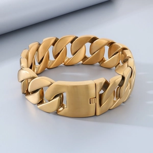 Close-up of golden stainless steel Cuban link bracelet with polished finish and clasp