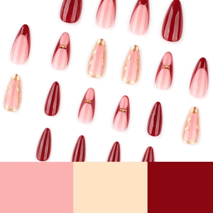 French red almond press-on nails set with gold accents and gradient pink patterns