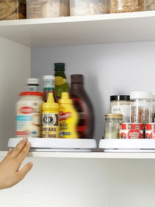 Rotating white pantry organizers showing versatile storage for kitchen spice jars