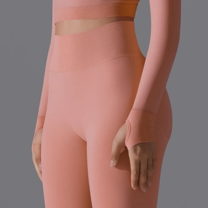 Detailed view of seamless high-waisted orange yoga leggings with ribbed waistband and thumbholes