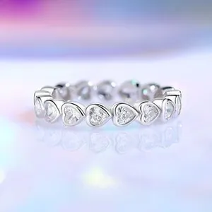Macro shot of S925 silver ring featuring heart-cut cubic zirconia in a full eternity band