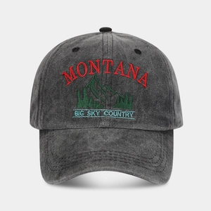 Detail of Montana mountain embroidery on washed dark gray cotton baseball cap