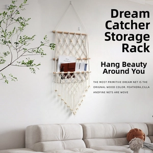 Detail of bohemian three-tier hand-woven cotton macrame wall shelf with tassels