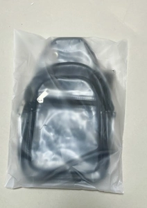 Detailed view of black waterproof PVC sports chest bag packed in a transparent poly bag