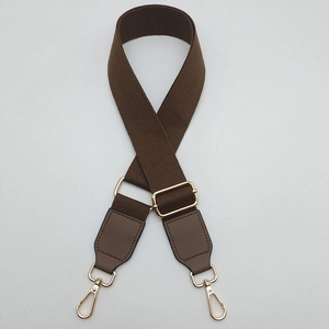 Adjustable brown canvas strap with thick woven texture and polished gold metal buckles