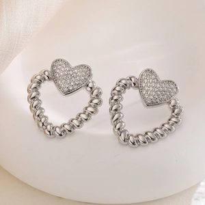 Minimalist silver heart-shaped stud earrings with sparkling cubic zirconia inlays