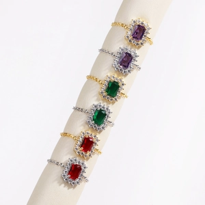 Macro shot of rectangular gemstone chain rings with adjustable bands and diamond halo