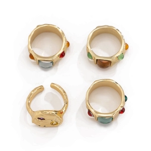 Set of four gold vintage rings with colorful gemstones and liquid metal finish