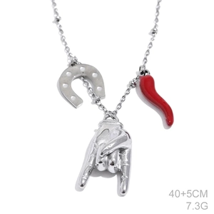 Detailed shot of silver rock gesture and red chili charms on a delicate bead chain