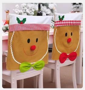 Close-up of gingerbread man chair covers with festive red and green decorative bows