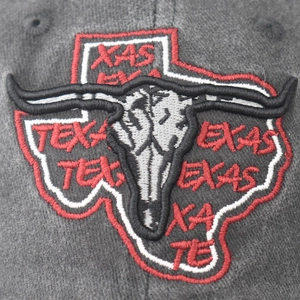 Macro view of 3D Texas embroidery and longhorn skull on charcoal grey baseball cap