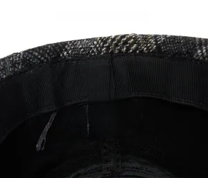 Care label detail showing 35% cotton 65% polyester material for plaid fedora hat