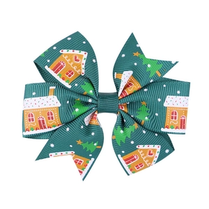 Detail of green Christmas bow hair clip with gingerbread man and festive patterns