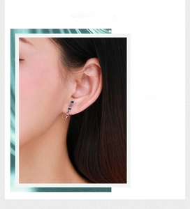 Detail of colorful gemstone ear crawler in S925 sterling silver on model ear