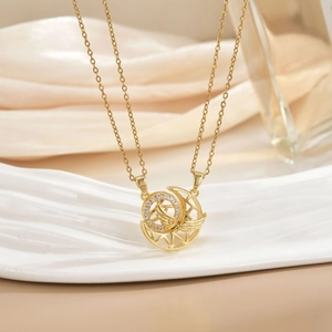 Detail view of a gold-plated double-layer necklace with micro-set zircon moon pendant